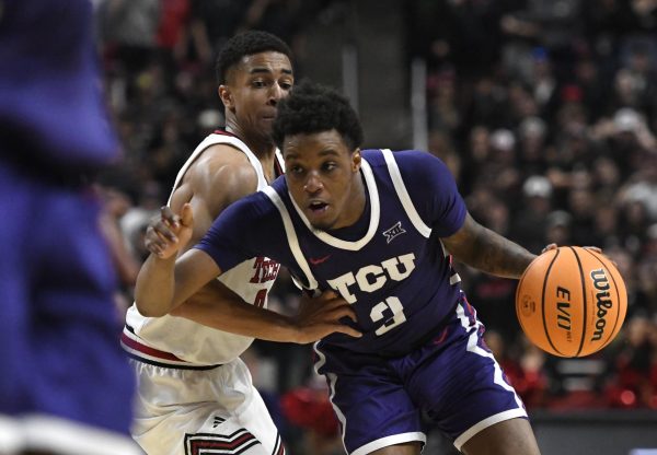 TCU's guard Vasean Allette (3) dribbles the ball while Texas Tech's guard Chance McMillian guards during the first half in an NCAA college basketball game, Wednesday, Jan. 29, 2025, in Lubbock, Texas. 