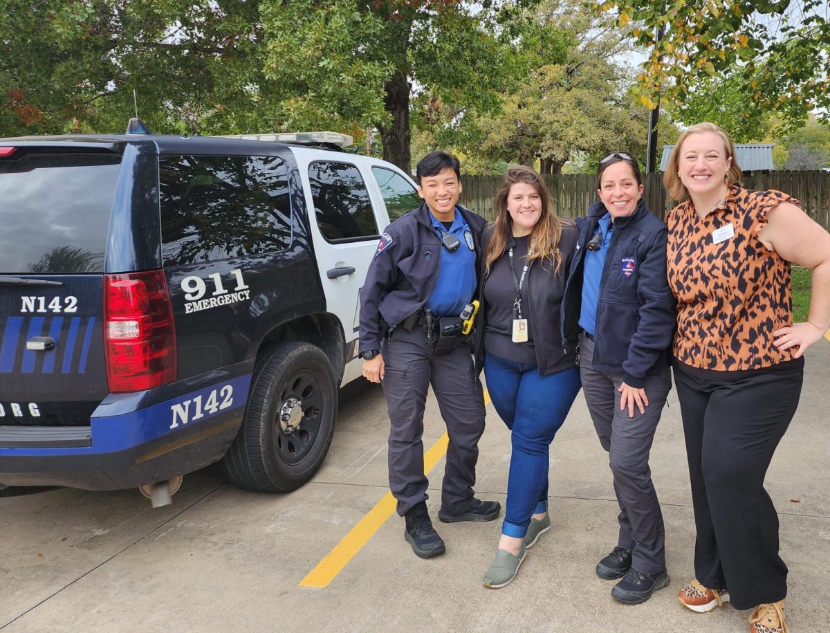 Anastasia Taylor posing with members of the Arlington Police Department Behavioral Health Law Enforcement Unit. EmpathyHQ partners with them regularly to serve Clients who are experiencing a crisis that is escalating to the point of police intervention.