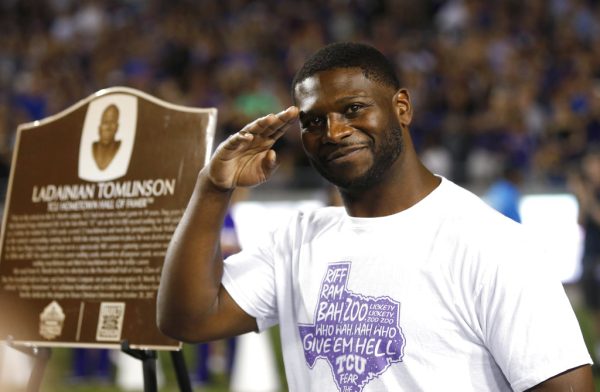 Pro Football Hall of Famer LaDainian Tomlinson smiles and salutes as he is recognized during homecoming events as TCU played Kansas in an NCAA college football game Saturday, Oct. 21, 2017, in Fort Worth, Texas. (AP Photo/Ron Jenkins)