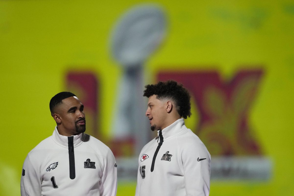 Philadelphia Eagles quarterback Jalen Hurts (1) and Kansas City Chiefs quarterback Patrick Mahomes (15) pose with the trophy during Super Bowl 59 Opening Night, Monday, Feb. 3, 2025, in New Orleans, ahead of the NFL football game between the Philadelphia Eagles and the Kansas City Chiefs Sunday. (AP Photo/Matt York)