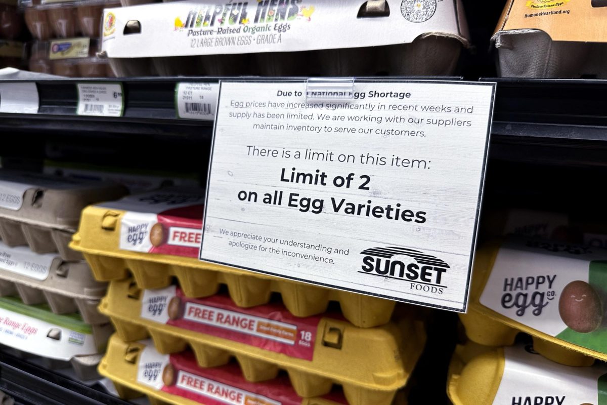 A sign is mounted on a shelve of eggs at a grocery store in Northbrook, Ill., Friday, Feb. 28, 2025. 