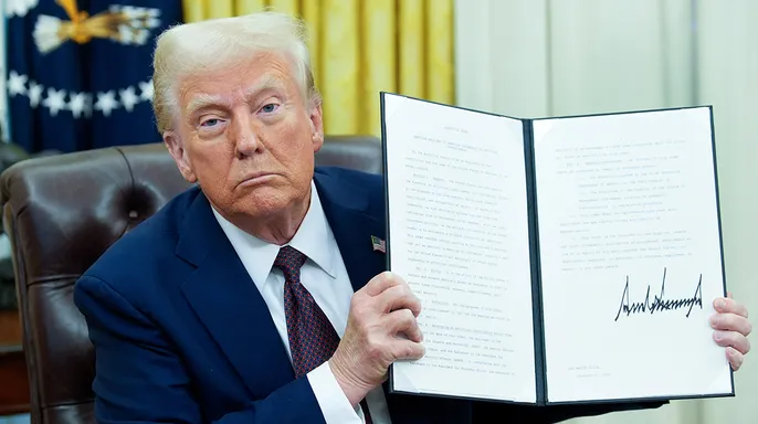 President Donald Trump signs an executive order in the Oval Office of the White House in Washington, D.C., Jan. 23, 2025. (Yuri Gripas/Abaca/Bloomberg via Getty Images)