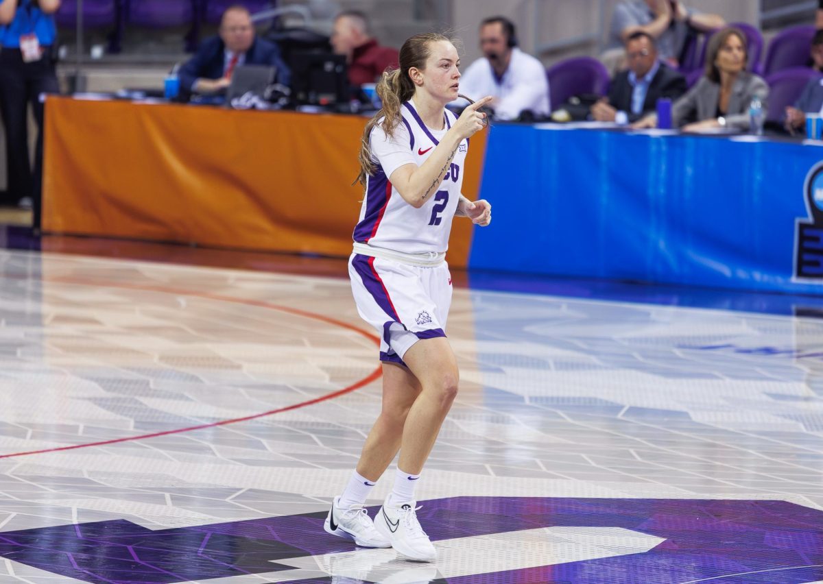 TCU guard Madison Conner points to her teammate after the play at Schollmaier Arena in Fort Worth, Texas, on March 21, 2025. The TCU Horned Frogs beat the FDU Knights 73-51. 