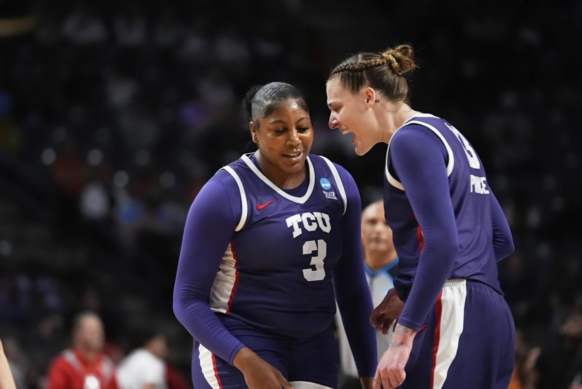 TCU center Sedona Prince (13) reacts with forward Deasia Merrill (3) during the first half against Texas in the Elite Eight of the NCAA college basketball tournament, Monday, March 31, 2025. in Birmingham, Ala. (AP Photo/Gerald Herbert)