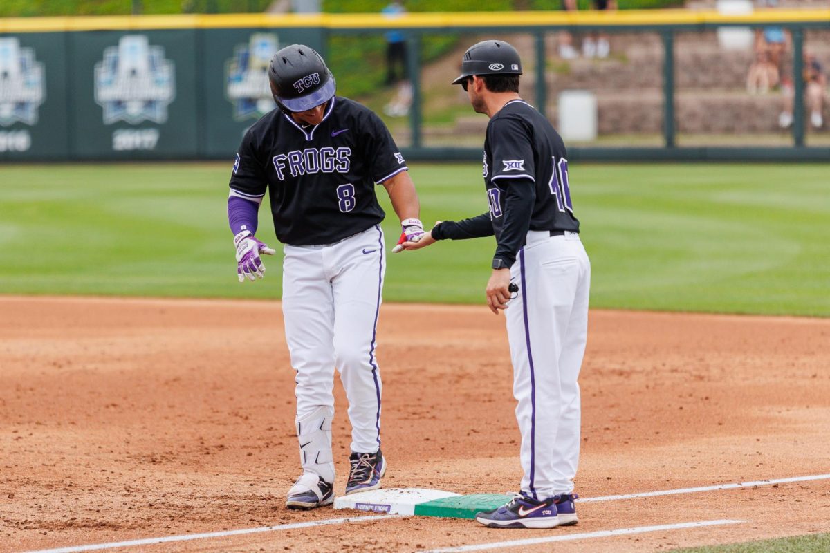 TCU left fielder Isaac Cadena high fives the coaches hand at Lupton Stadium in Fort Worth, Texas Apr. 27, 2025. (TCU360/Tyler Chan)