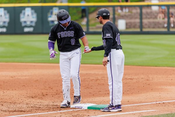 TCU left fielder Isaac Cadena high fives the coaches hand at Lupton Stadium in Fort Worth, Texas Apr. 27, 2025. (TCU360/Tyler Chan)