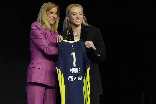 UConn's Paige Bueckers, right, poses for a photo with WNBA commissioner Cathy Engelbert after being selected first overall by the Dallas Wings during the first round of the WNBA basketball draft, Monday, April 14, 2025, in New York. (AP Photo/Pamela Smith)