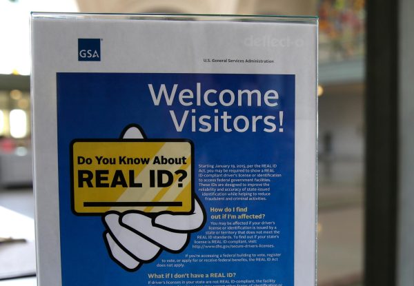 In this photo taken April 6, 2016, a sign at the federal courthouse in Tacoma, Wash., is shown to inform visitors of the federal government's REAL ID act. (AP Photo/Ted S. Warren, file)