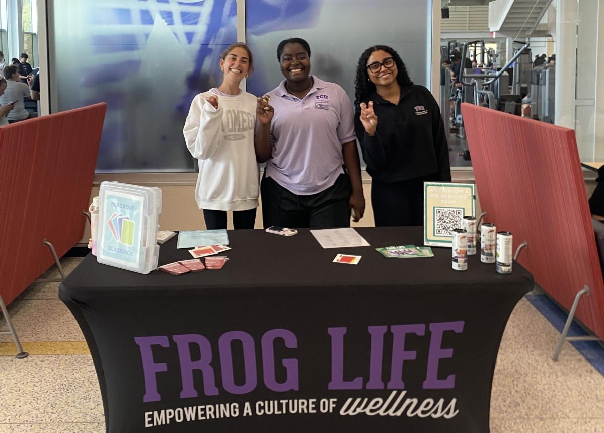 Frog Life members, Cardy Muschick (left), Rachel Ndekelengwe (center) and Jasmine Franklin (right) working the table, April 1, 2025. (Cal Phillips/Staff Writer)