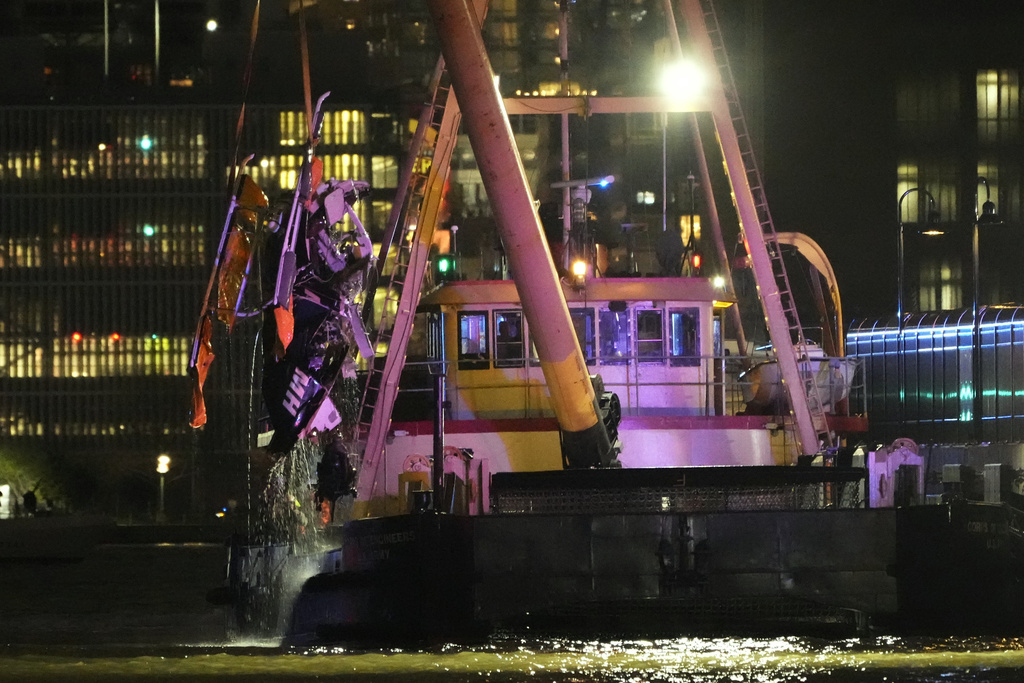 A crane vessel lifts the wreckage of a helicopter that crashed into the Hudson River, Thursday, April 10, in Jersey City, N.J. (AP Photo/Seth Wenig)