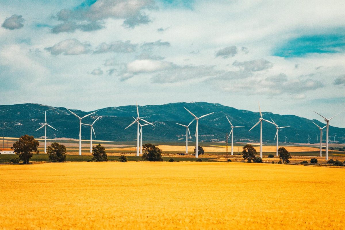 Large wind turbines producing clean sustainable energy. (Raimond Klavins/Unsplash)