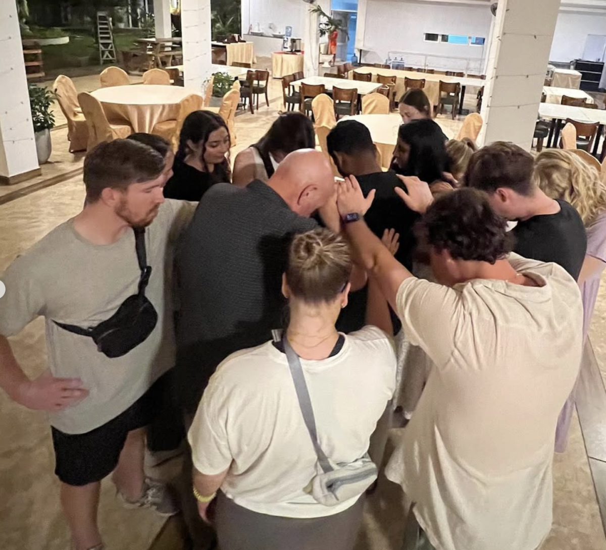 The Sri Lankan mission trip team prays over a man. (Photo courtesy of Eunice Kay)