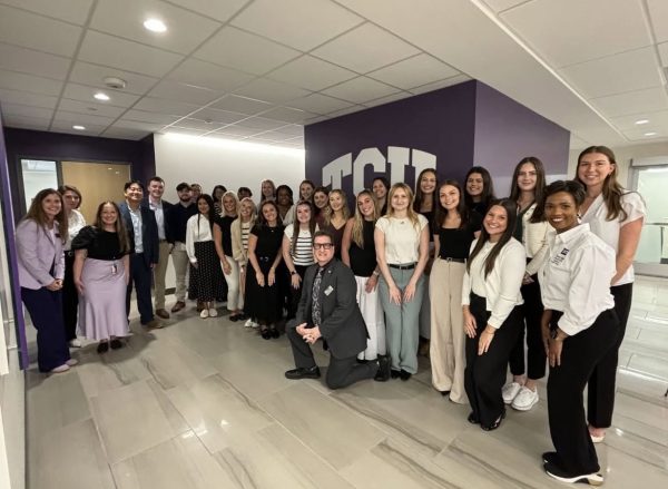 Students in the cohort pose with their professors for the first day of classes in the program. (@tcuotd on Instagram)
