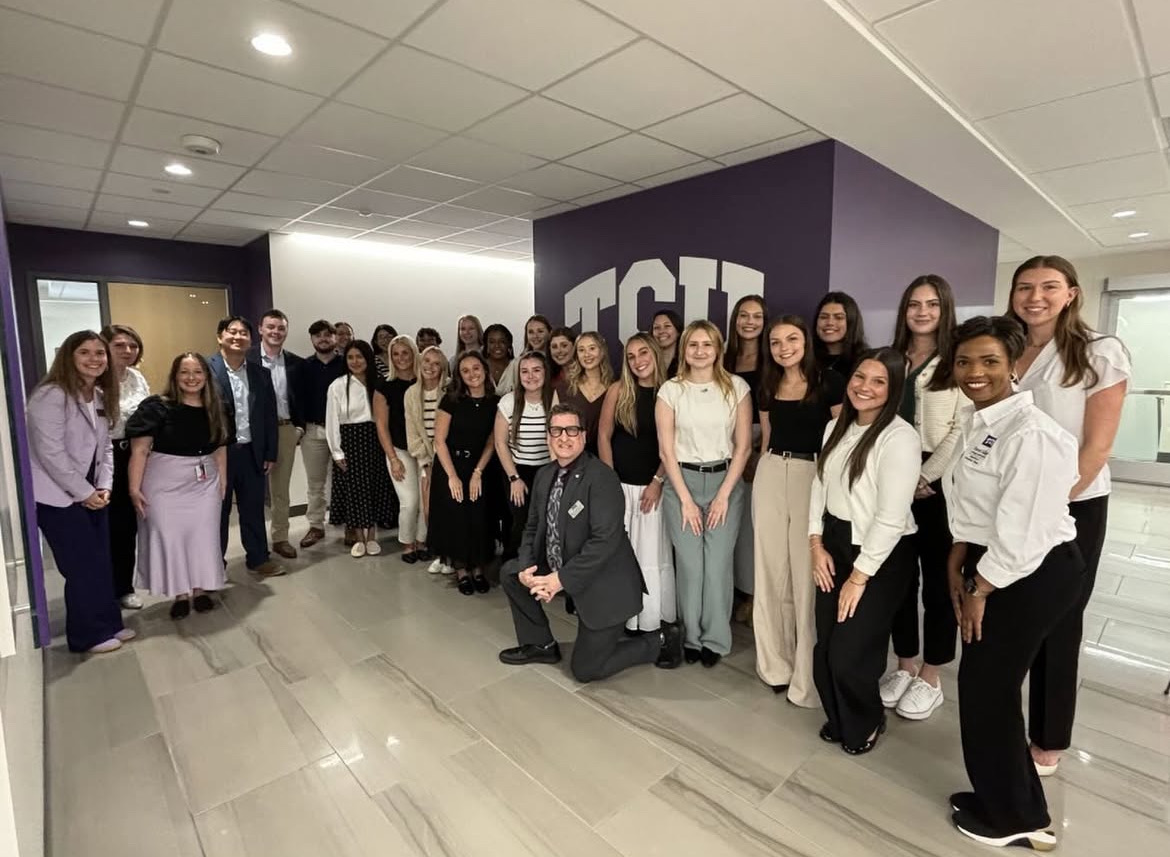 Students in the cohort pose with their professors for the first day of classes in the program. (@tcuotd on Instagram)
