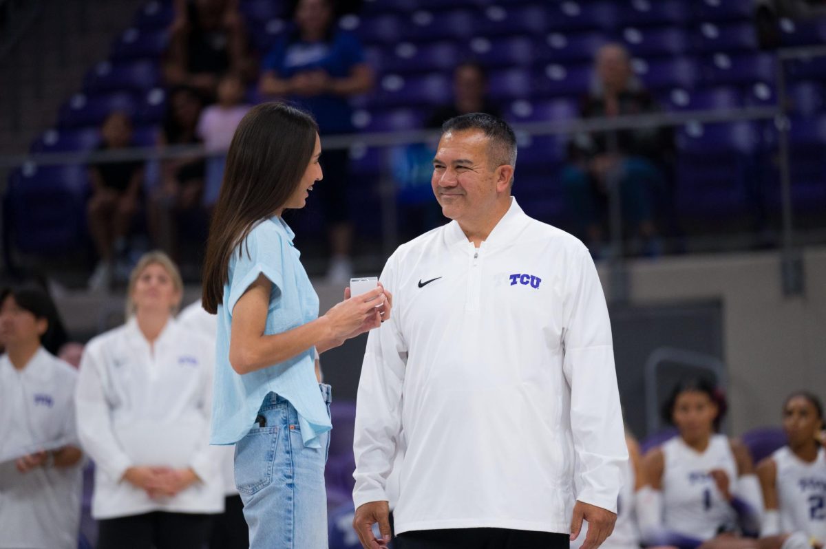 Head coach Jason Williams presents former TCU volleyball player Melanie Parra with a All-American ring at Schollmaier Arena in Fort Worth, Texas, Sep. 24, 2025. The TCU Horned Frogs beat the Houston Cougars 3-0. (TCU360/Keegan Schmidt)