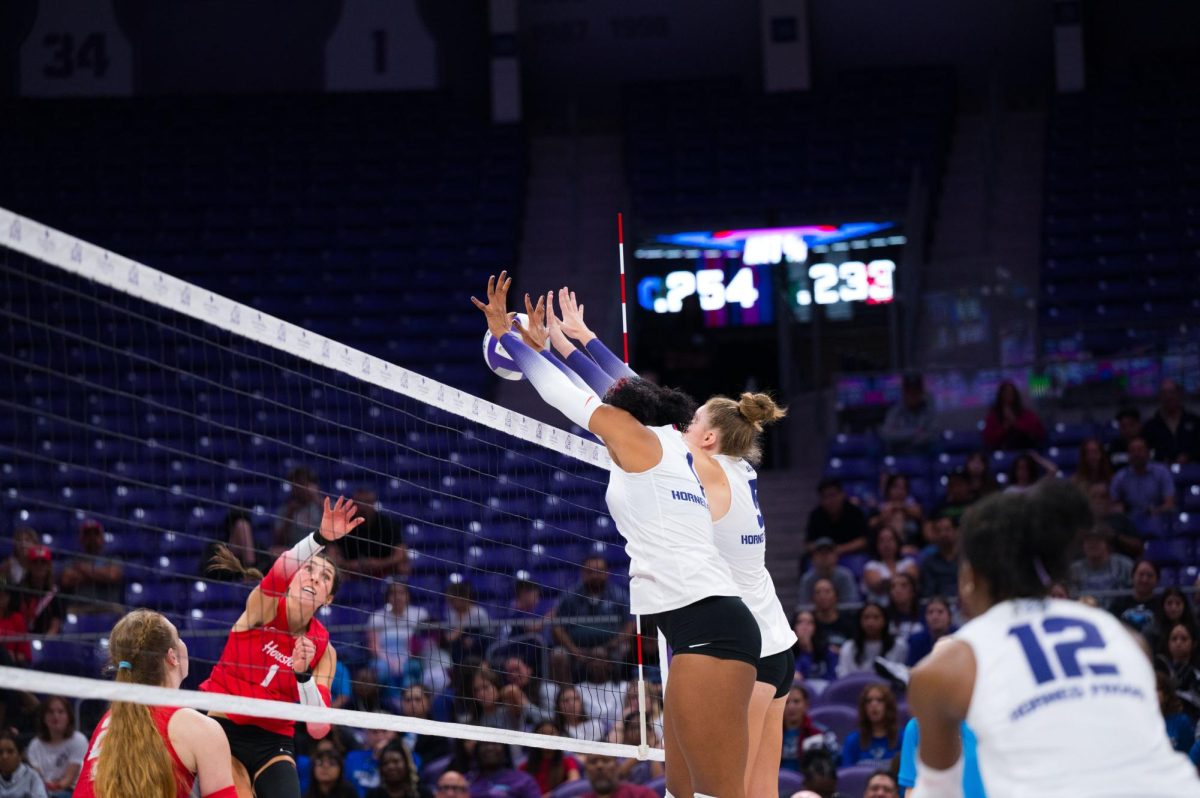 TCU middle blocker Alexis Roberson and  right-side hitter Lauren Murphy block the hit at Schollmaier Arena in Fort Worth, Texas, Sep. 24, 2025. The TCU Horned Frogs beat the Houston Cougars 3-0. (TCU360/Keegan Schmidt)