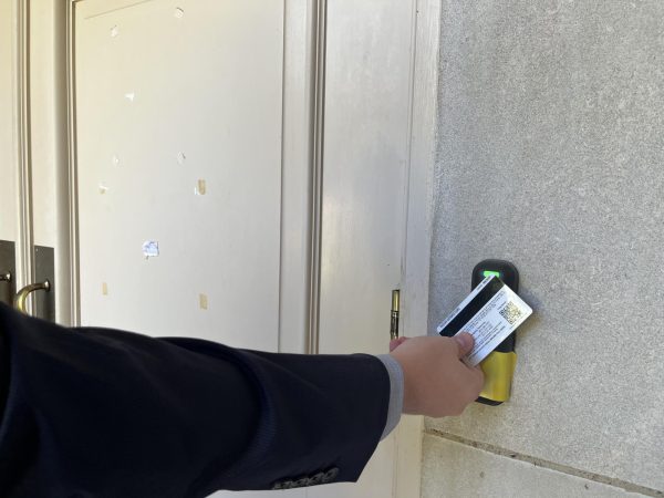 A student uses the new tap ID card. Many buildings already have the new scanners making it difficult for majors to access their classrooms and materials after hours.