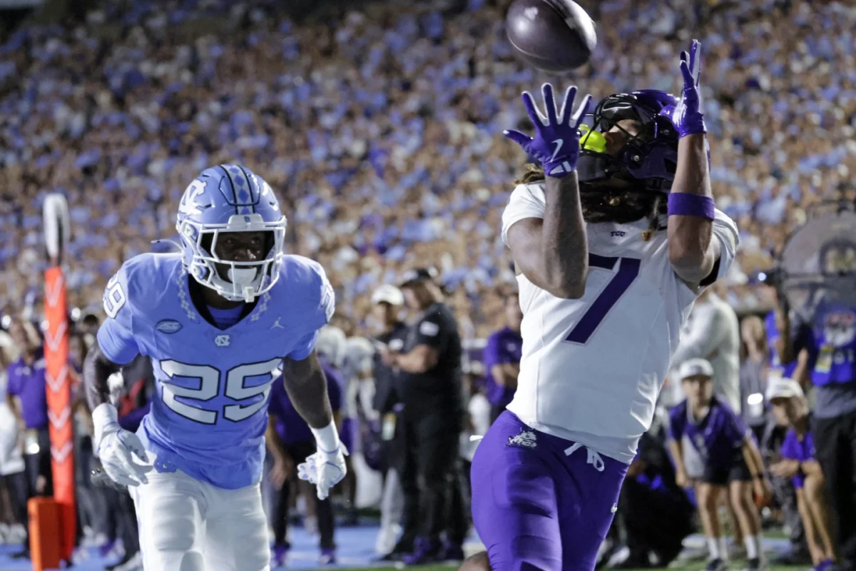 TCU wide receiver Jordan Dwyer (7) hauls in pass over North Carolina defensive back Marcus Allen (29) during the first half of an NCAA college football game Monday, Sept. 1, 2025, in Chapel Hill, N.C. (AP Photo/Chris Seward)