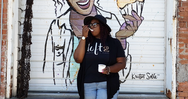 Lofton posing in front of a mural by her bakery (courtesy of Tareka Lofton)