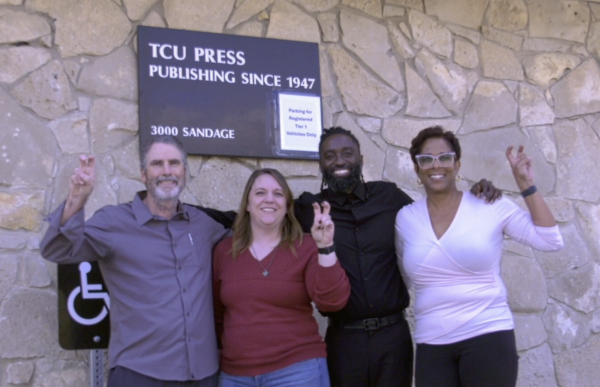 TCU Press Staff stands in front of their building on Sandage Avenue.