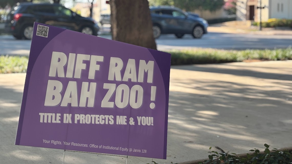 A Title IX yard sign in front of Moudy South off of University Drive.