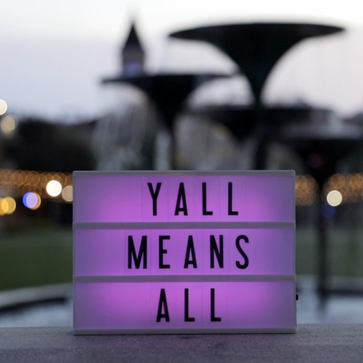 A "y'all means all" sign in front of Frog Fountain, a common saying representing inclusion of the LGBTQ+ community. (TCU Center for Connection Culture)