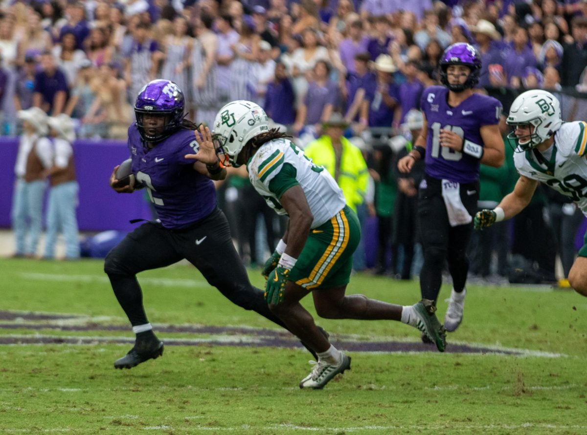 TCU running back Kevorian Barnes attempts to stiff-arm Baylor safety DJ Coleman (33) at Amon G. Carter Stadium in Fort Worth, Texas Oct 18, 2025. The TCU Horned Frogs defeated the Baylor Bears 42-36 (TCU360/Logan Pope).
