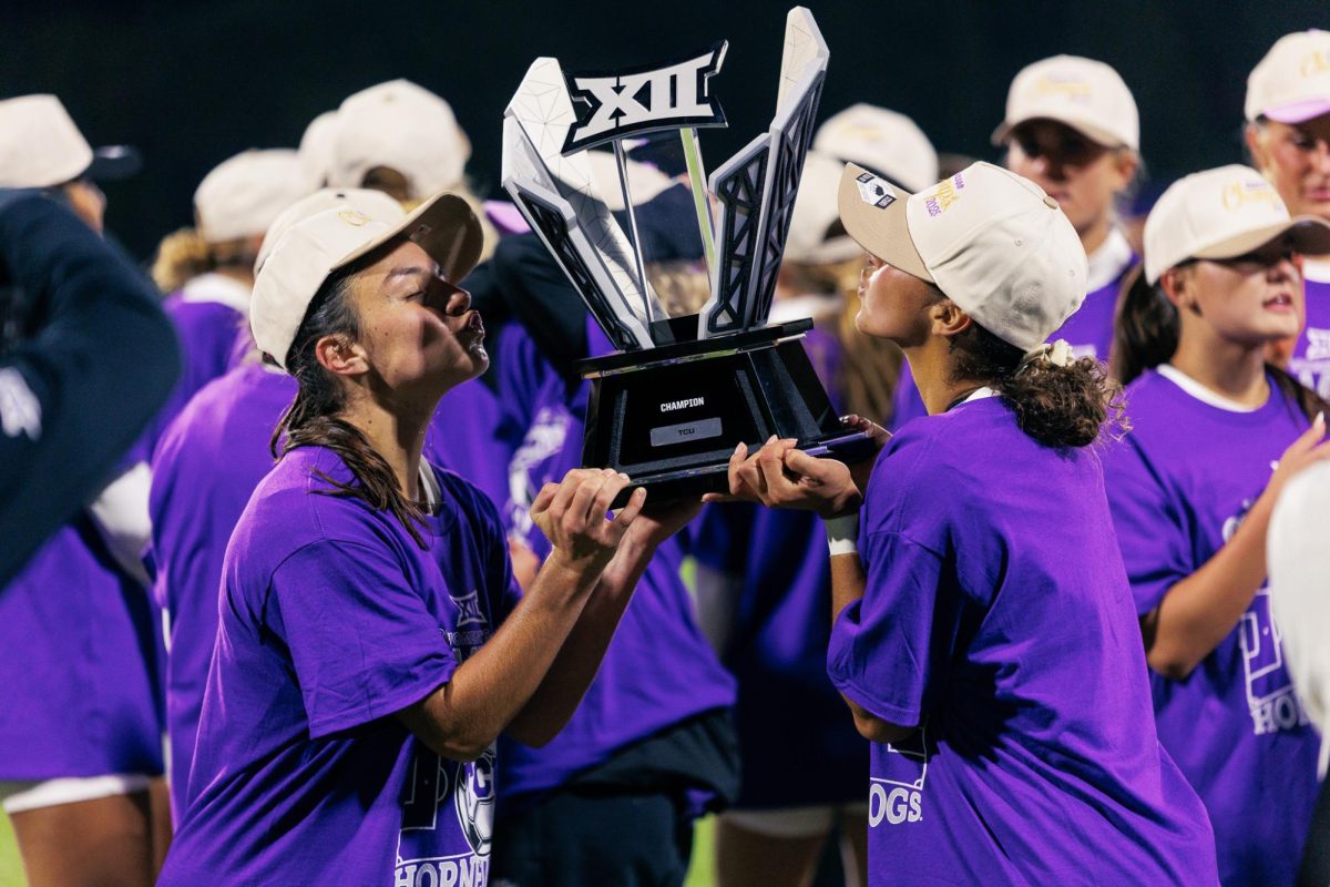 TCU players AJ Hennessey (left) and Seven Castain (right) holding the Big 12 regular season champions trophy after the game at Garvey Rosenthal Stadium in Fort Worth, Texas, Oct. 30, 2025. The TCU Horned Frogs beat the Houston Cougars 2-0. (TCU360/Tyler Chan)