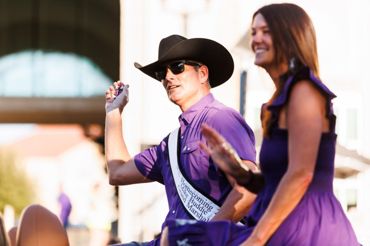 TCU athletic director Mike Buddie throwing beads out to the crowd during the homecoming parade in Fort Worth, Texas Oct. 17, 2025. (TCU360/ Tyler Chan)