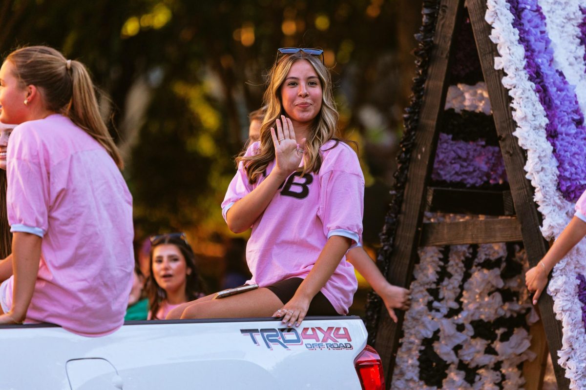 A Gamma Phi Beta member waves to the crowd while riding on a float during the TCU homecoming parade in Fort Worth, Texas Oct. 17, 2025. (TCU360/ Tyler Chan)