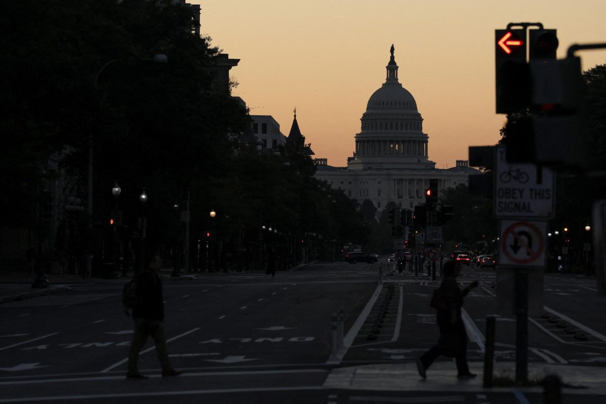 The sky begins to brighten just before sunrise behind the U.S. Capitol on the second day of a federal government shutdown in Washington, D.C., U.S., October 2, 2025. REUTERS/Jonathan Ernst