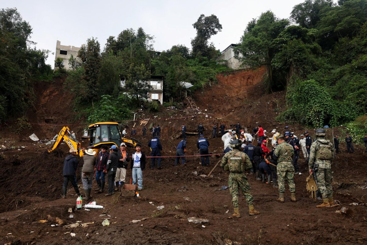 Members of security forces and rescue teams search for people after homes were buried by landslides following torrential rains, in Huauchinango, Mexico, October 14, 2025. REUTERS/Henry Romero