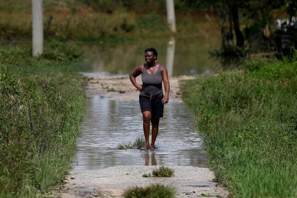 A woman walks after Hurricane Melissa made landfall, in Santa Cruz, Jamaica, October 29, 2025. REUTERS/Octavio Jones