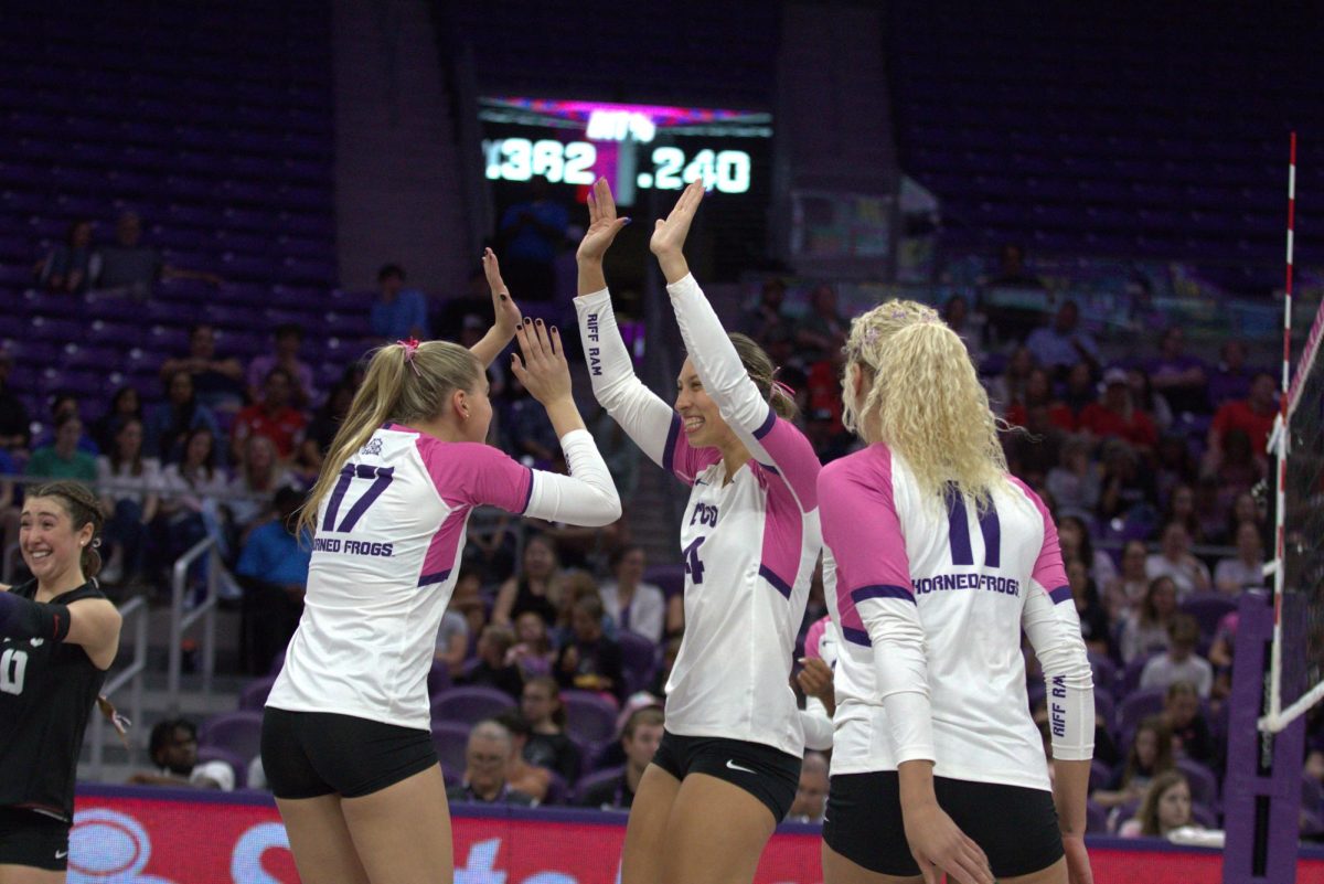 TCU setter Rosemary Archer (17), middle blocker Sarah Sylvester (4), and outside hitter Becca Kelley (11) celebrate winning a point at Schollmaier Arena in Fort Worth, Texas Oct. 15, 2025. The TCU Horned Frogs beat the Cincinnati Bearcats 3-1 (TCU360/Logan Pope).