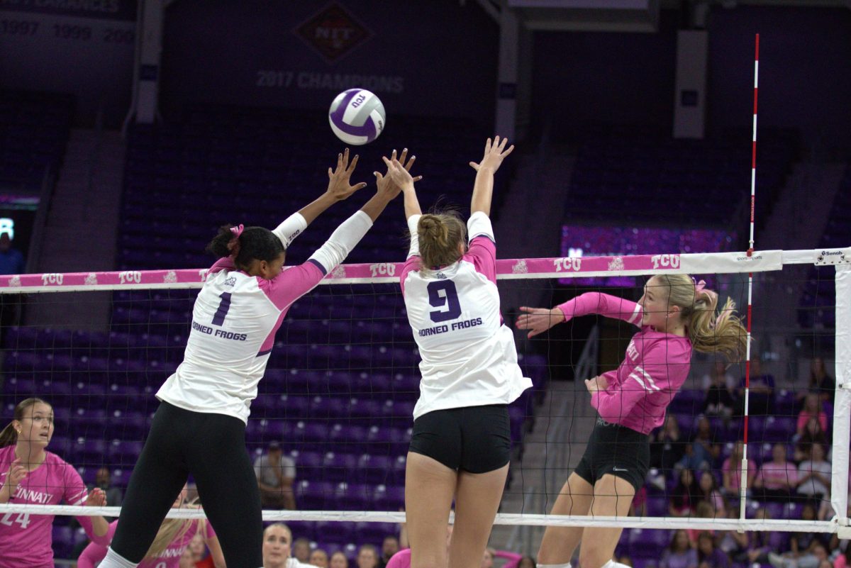 TCU middle blocker Alexis Roberson (1) and opposite hitter Lauren Murphy (9) block a Cincinnati hit at Schollmaier Arena in Fort Worth, Texas Oct. 15, 2025. The TCU Horned Frogs beat the Cincinnati Bearcats 3-1 (TCU360/Logan Pope).