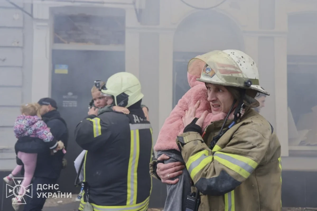 In this photo provided by the Ukranian Emergency Service, rescuers evacuate children after Russian drones hit a city kindergarten during an attack in Kharkiv, Ukraine, Wednesday, Oct. 22, 2025.