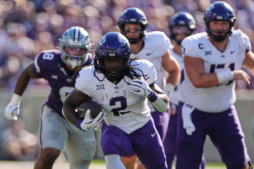 TCU running back Kevorian Barnes runs the ball during the first half of an NCAA college football game against Kansas State, Saturday, Oct. 11, 2025, in Manhattan, Kan. (AP Photo/Charlie Riedel)