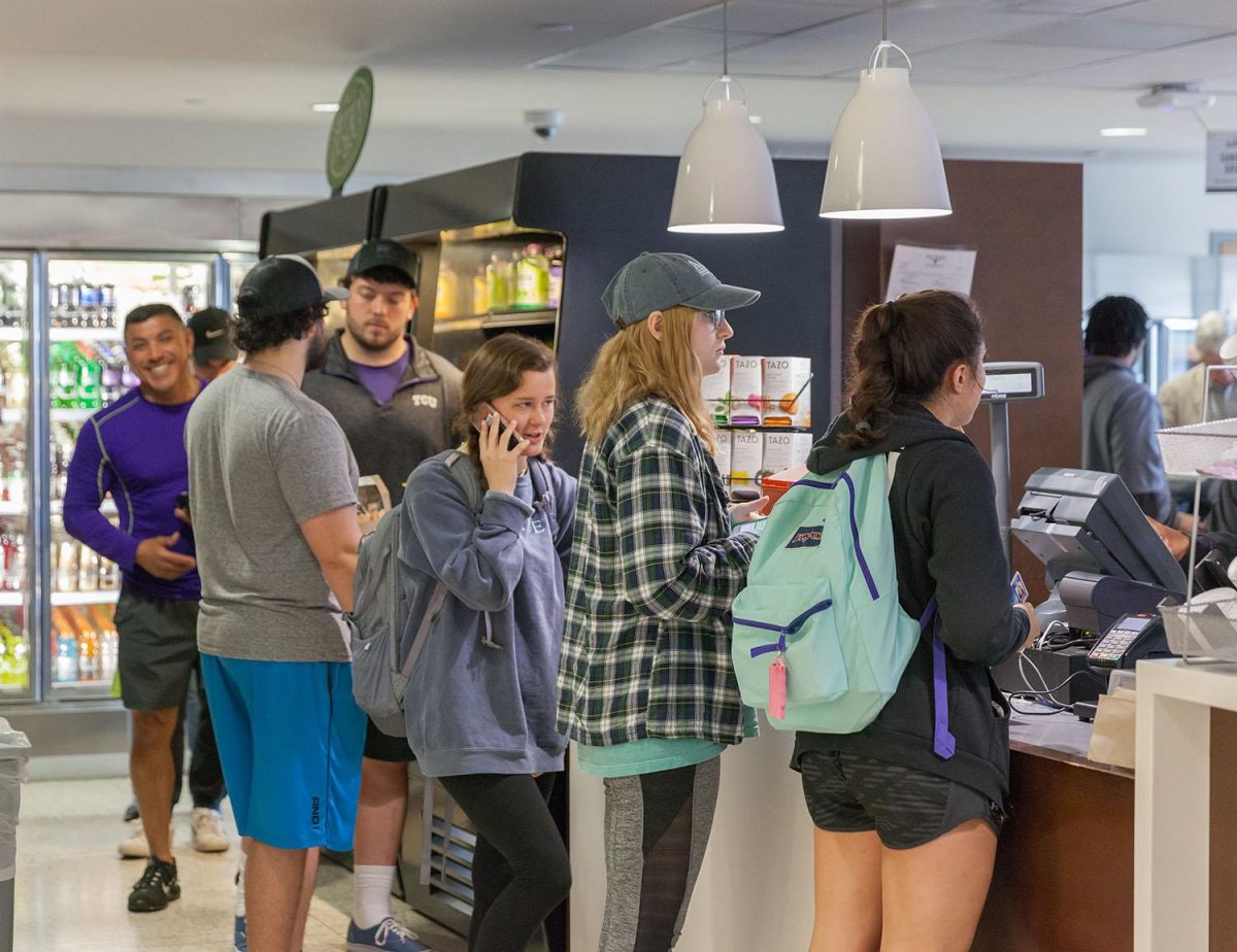 Students wait in line for coffee Bistro Burnett, located in the Mary Couts Burnett Library