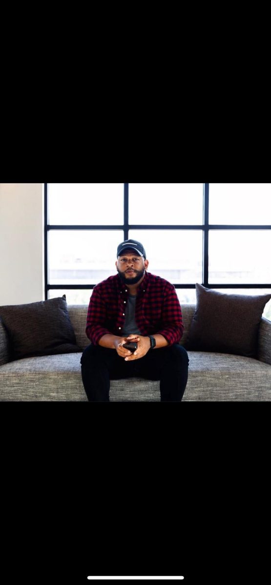 Jae Oats sitting down at a photoshoot in Friso, Texas. (Courtesy of Jae Oats)