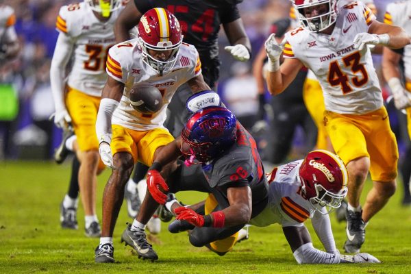 TCU running back Jeremy Payne (26) fumbles the ball against Iowa State defensive backs Tre Bell (7), David Coffey (18) and Caden Matson (43) during the second half of an NCAA college football game Saturday, Nov. 8, 2025, in Fort Worth, Texas. (AP Photo/LM Otero)
