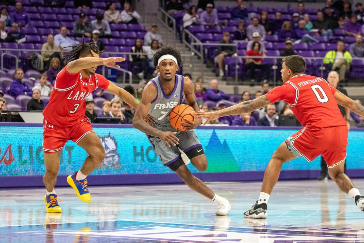TCU guard Kayden Edwards forces his way past Lamar guards King-Njhsanni Wilhite (3) and Cody Pennebaker (0) at Ed and Rae Schollmaier Arena in Fort Worth, Texas Nov. 10, 2025. The Horned Frogs defeated the Lamar Cardinals 78-65 (TCU360/Logan Pope).