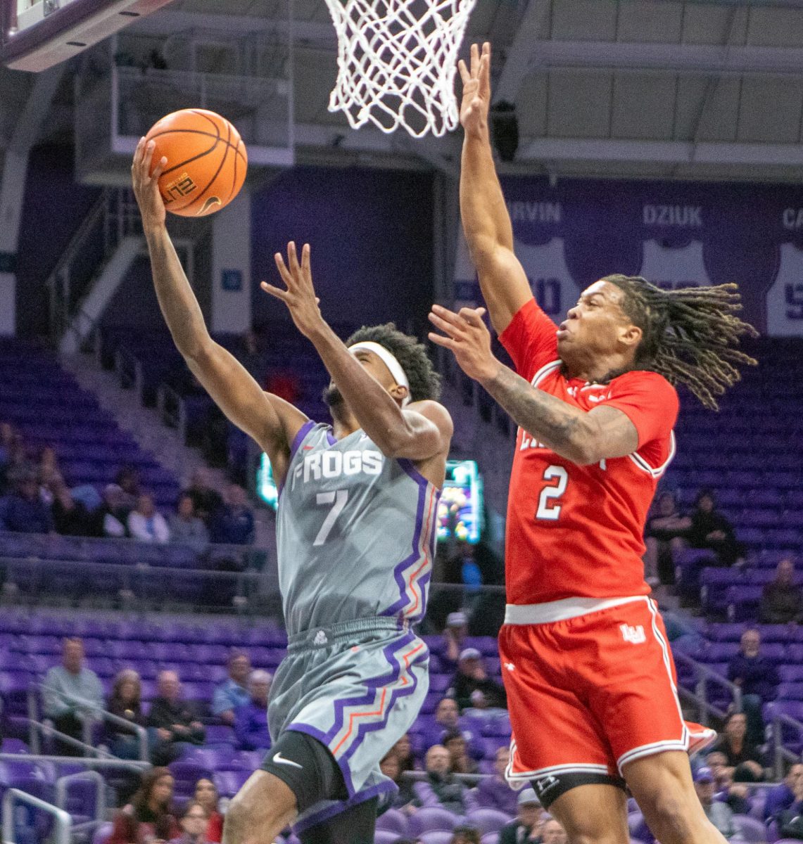 TCU guard Kayden Edwards goes up for a layup against Lamar guard Jayden Barrs (2) at Ed and Rae Schollmaier Arena in Fort Worth, Texas Nov. 10, 2025. The Horned Frogs defeated the Lamar Cardinals 78-65 (TCU360/Logan Pope).