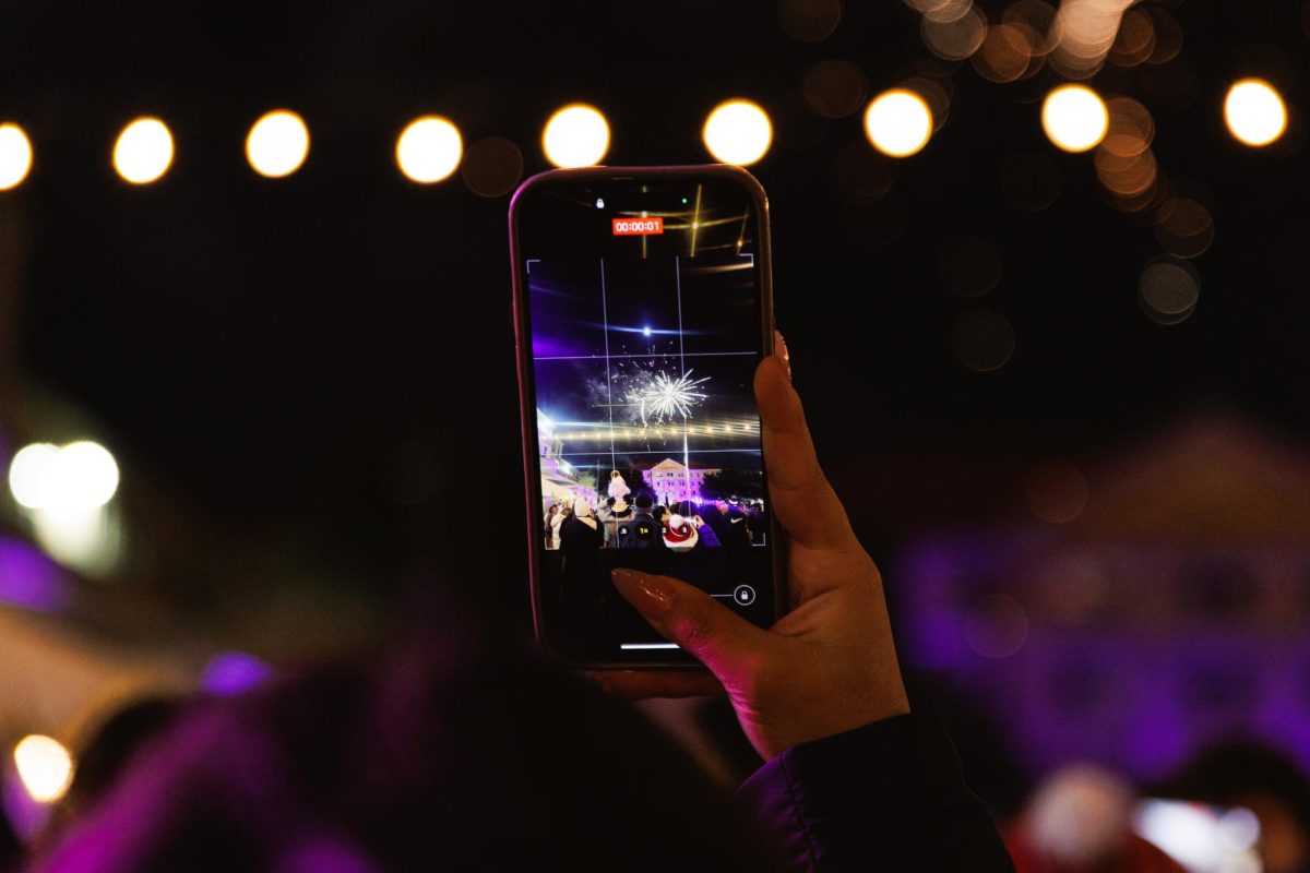 A student records the fireworks being shot off during the TCU Tree Lighting celebration in Fort Worth, Texas, Dec. 2, 2025. (TCU360/Tyler Chan)