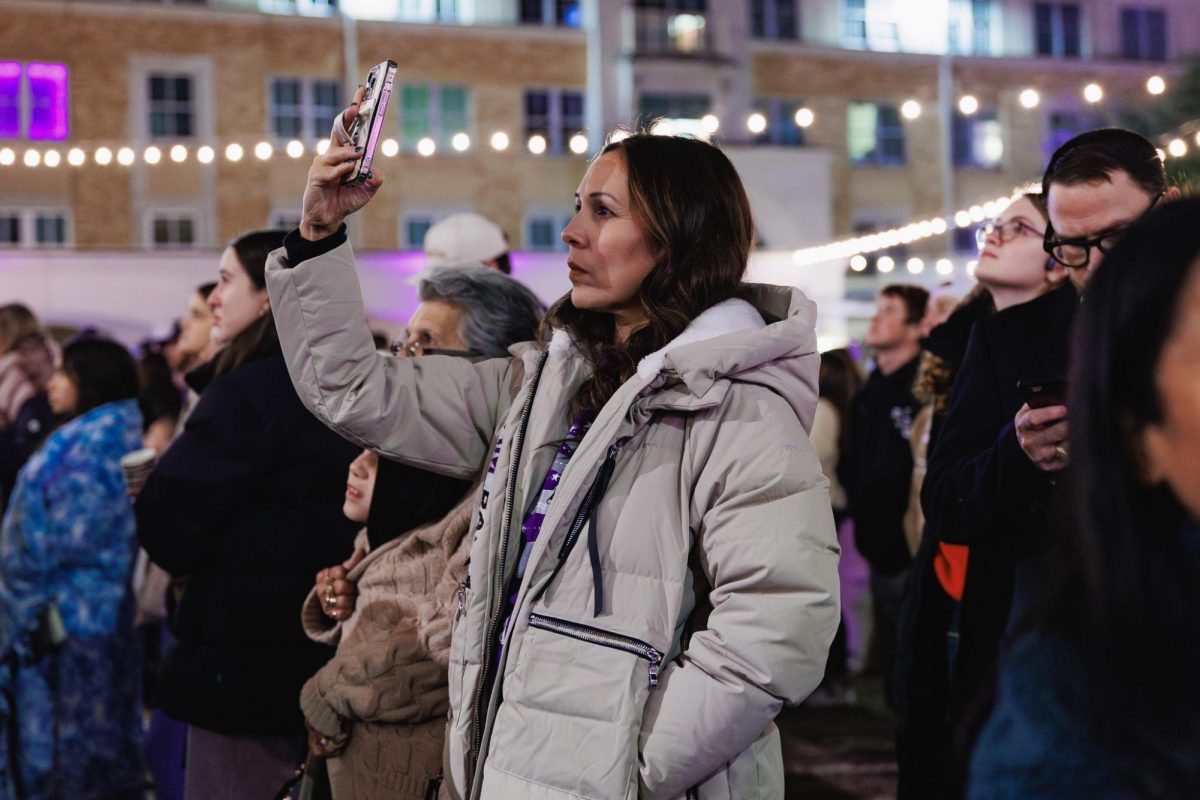 A spectator watches the fireworks show during the TCU Tree Lighting celebration in Fort Worth, Texas, Dec. 2, 2025. (TCU360/Tyler Chan)