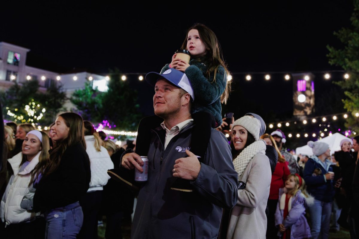 A dad and daughter watch the fireworks show the TCU Tree Lighting celebration in Fort Worth, Texas, Dec. 2, 2025. (TCU360/Tyler Chan)