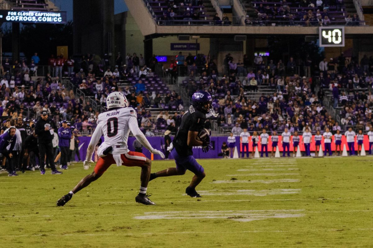 TCU Wide Receiver Eric McAlister carries the ball while evading a defender at Amon G. Carter Stadium in Fort Worth, Texas, on Nov. 29, 2025. The TCU Horned Frogs beat the Cincinnati Bearcats 45–23. (TCU360/Nghia Tran)