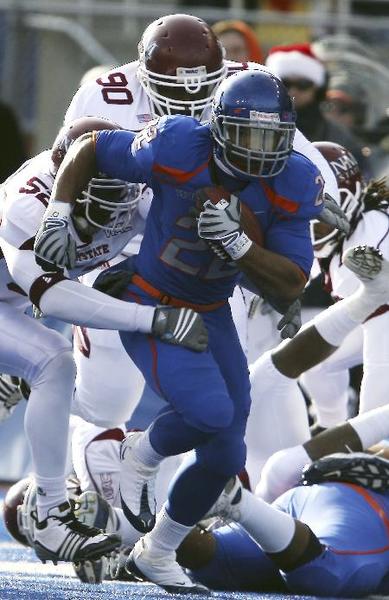 Boise States Doug Martin (22) breaks a tackle against New Mexico States Donte Savage (52) during the second half of an NCAA college football game on Dec. 5 in Boise, Idaho.  Boise State went on to win 42-7. Photo by Matt Cilley, Associated Press